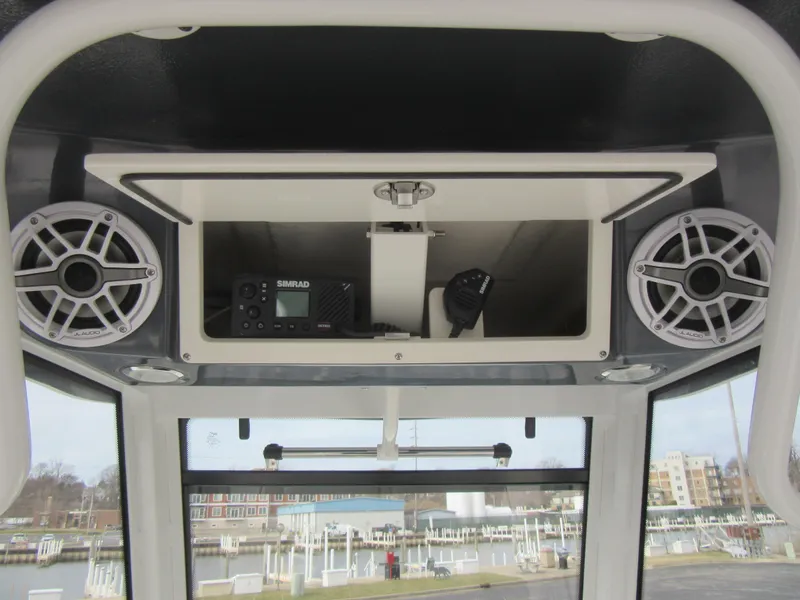 Slide: The Image of 2024 Robalo R250 Center Console overhead electronics and speaker system. - 14