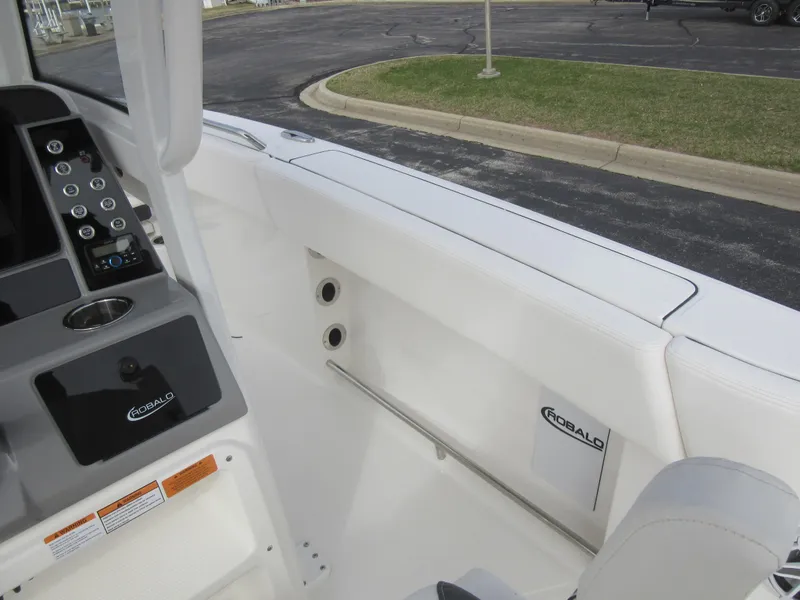 Slide: The Image of 2024 Robalo R250 Center Console boat interior with control panel and seating. - 18