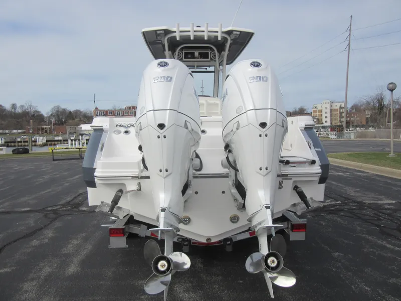 Slide: The Image of 2024 Robalo R250 Center Console with twin outboard engines, rear view. - 5