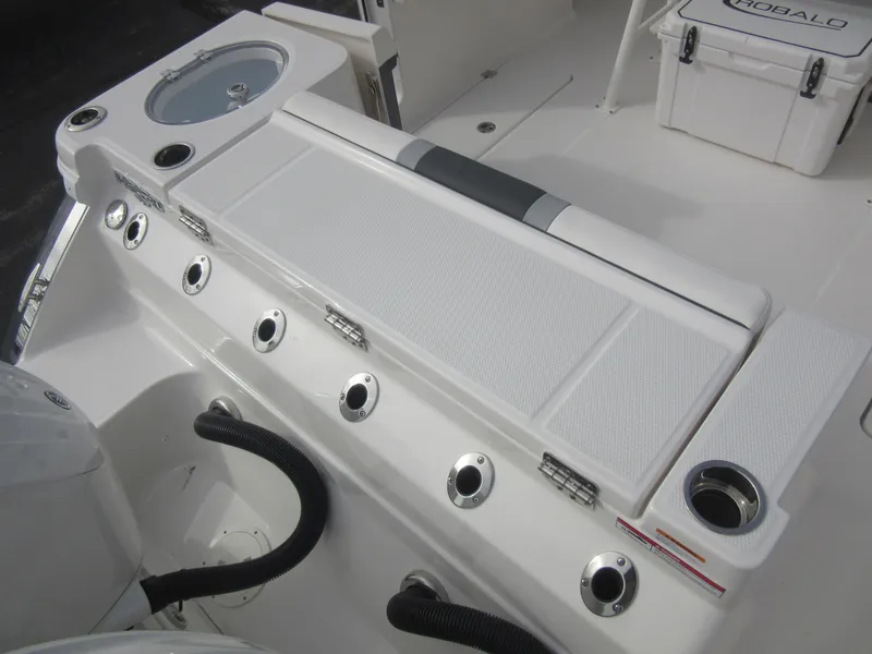 Slide: The Image of 2024 Robalo R250 Center Console boat deck with seating and storage compartments. - 7