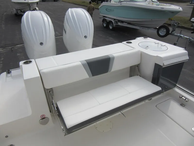 Slide: The Image of 2024 Robalo R250 Center Console boat with dual engines and fold-down seating. - 9