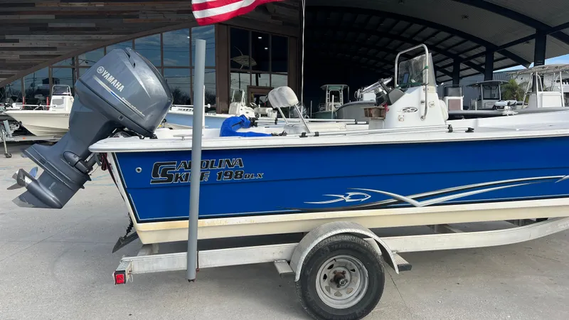 Slide: The Image of 2013 Carolina Skiff 198DLX boat with Yamaha outboard motor on trailer. - 2