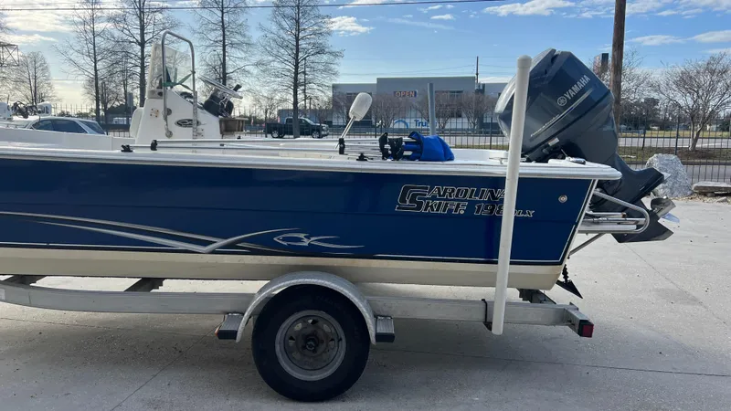 Slide: The Image of 2013 Carolina Skiff 198DLX boat on trailer with Yamaha outboard motor. - 6