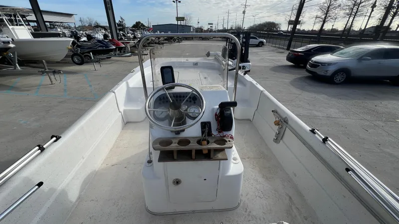 Slide: The Image of 2013 Carolina Skiff 198DLX center console boat in a parking lot. - 7