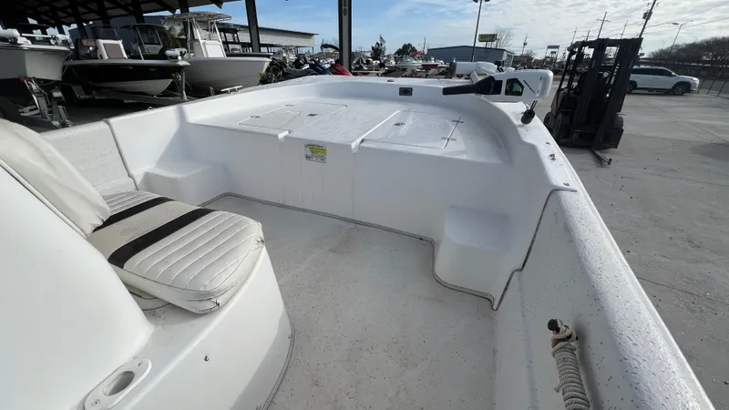 Slide: The Image of 2013 Carolina Skiff 198DLX boat interior with seating and storage compartments. - 9