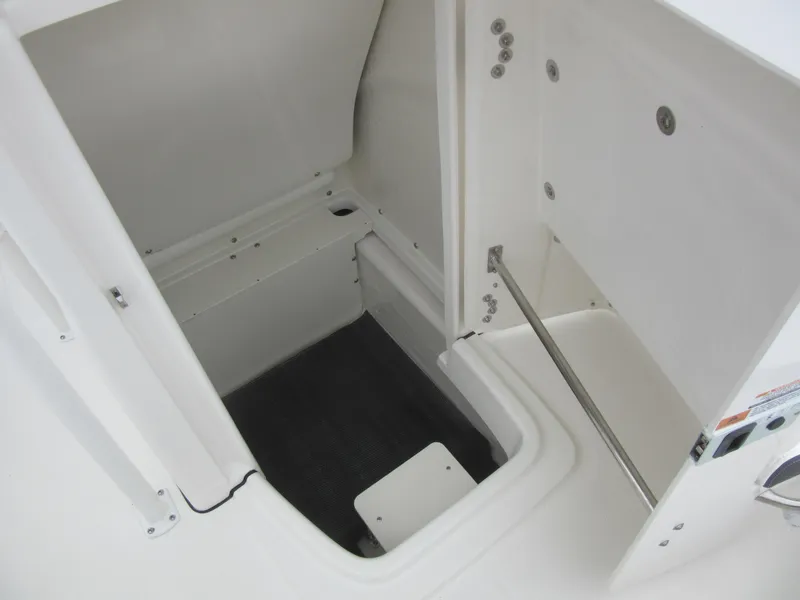 Slide: The Image of 2024 Robalo R180 Center Console storage compartment with open hatch. - 13