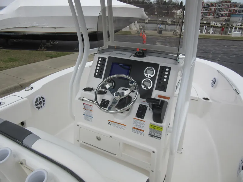 Slide: The Image of 2024 Robalo R180 Center Console boat dashboard and steering wheel. - 15