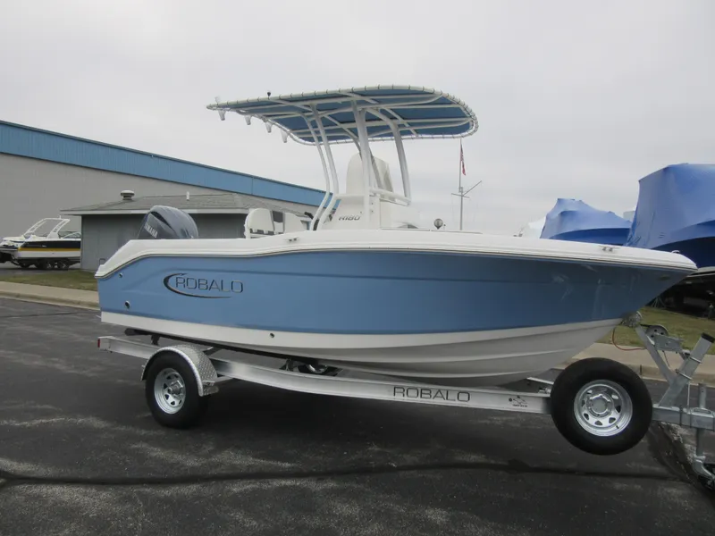 Slide: The Image of 2024 Robalo R180 Center Console boat on a trailer. - 3