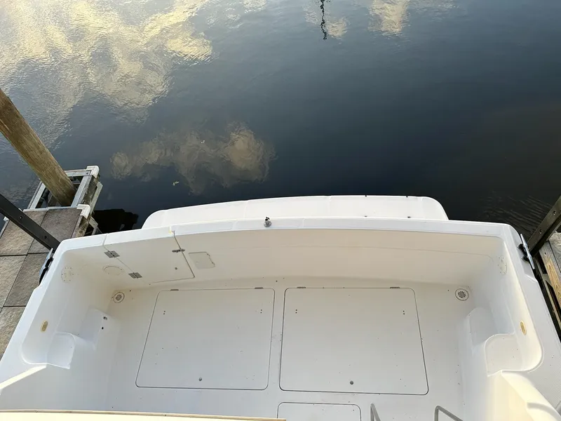 Slide: The Image of 1997 Bayliner 3988 Motoryacht stern view at dock, reflecting sky on water. - 11