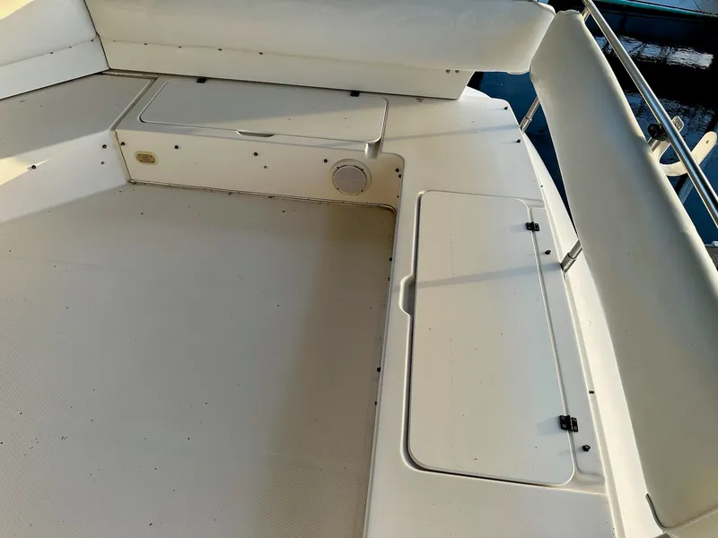 Slide: The Image of 1997 Bayliner 3988 Motoryacht deck with storage compartments and seating area. - 12