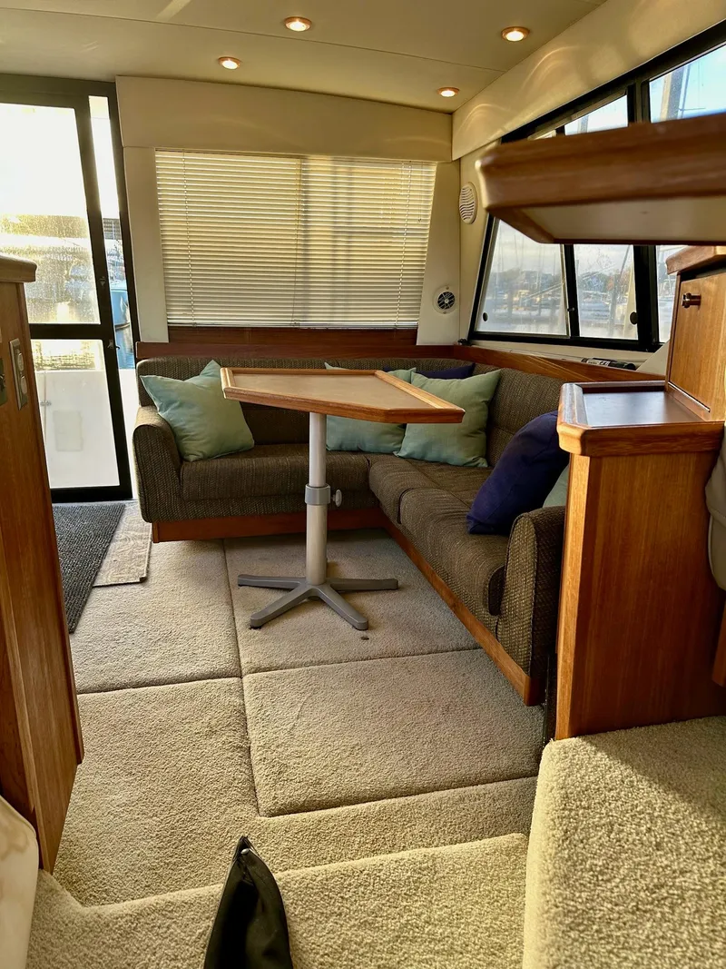 Slide: The Image of Interior of 1997 Bayliner 3988 Motoryacht with cozy seating and wooden table. - 13