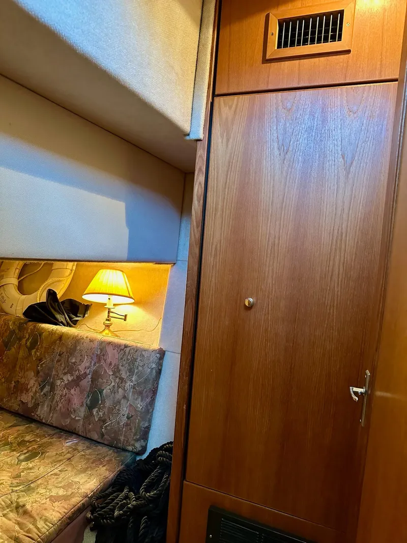 Slide: The Image of Cozy interior of 1997 Bayliner 3988 Motoryacht with wood paneling and soft lighting. - 15