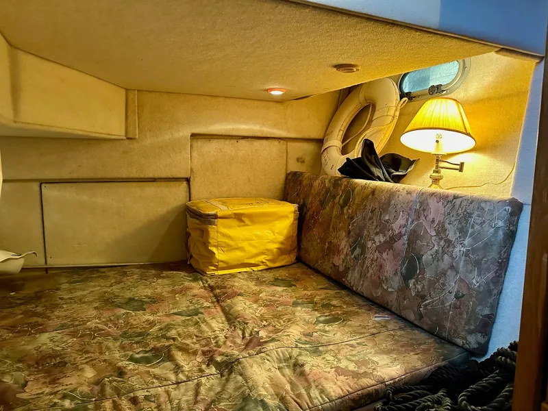 Slide: The Image of Cozy cabin interior of 1997 Bayliner 3988 Motoryacht with patterned cushions and a lamp. - 16