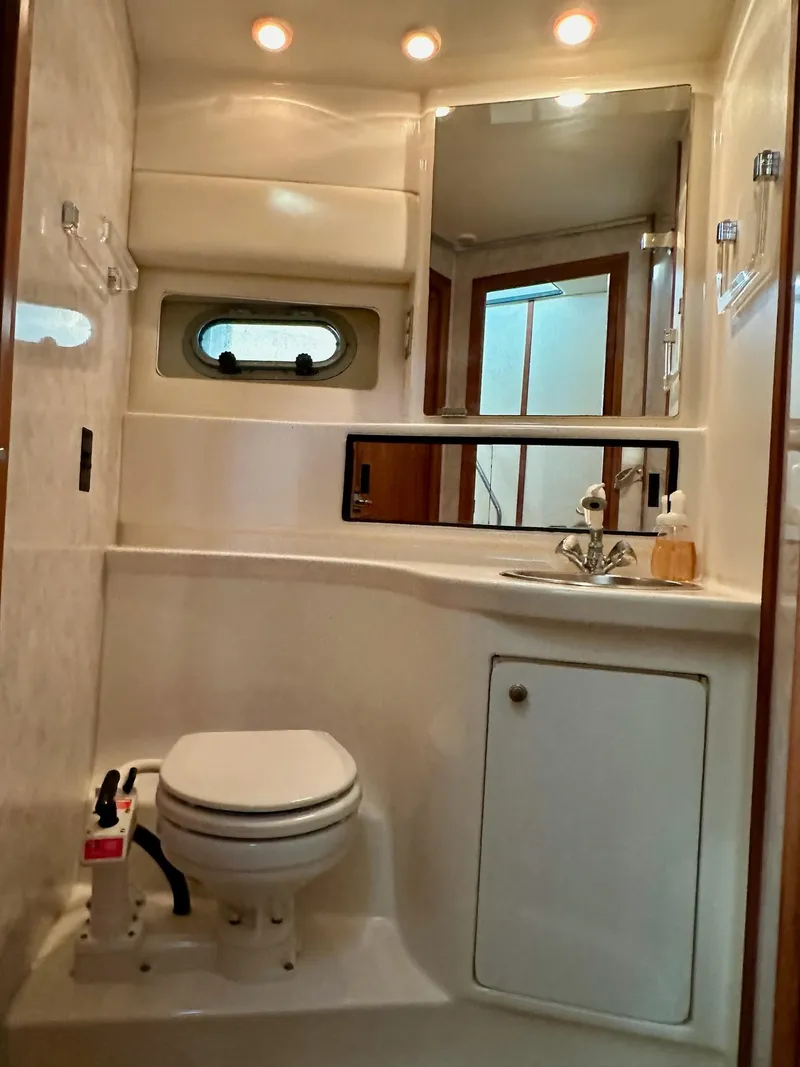 Slide: The Image of Bathroom interior of 1997 Bayliner 3988 Motoryacht with toilet, sink, and mirror. - 17