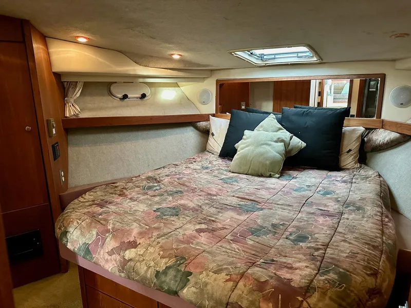 Slide: The Image of Cozy bedroom interior of 1997 Bayliner 3988 Motoryacht with floral bedding and soft lighting. - 18