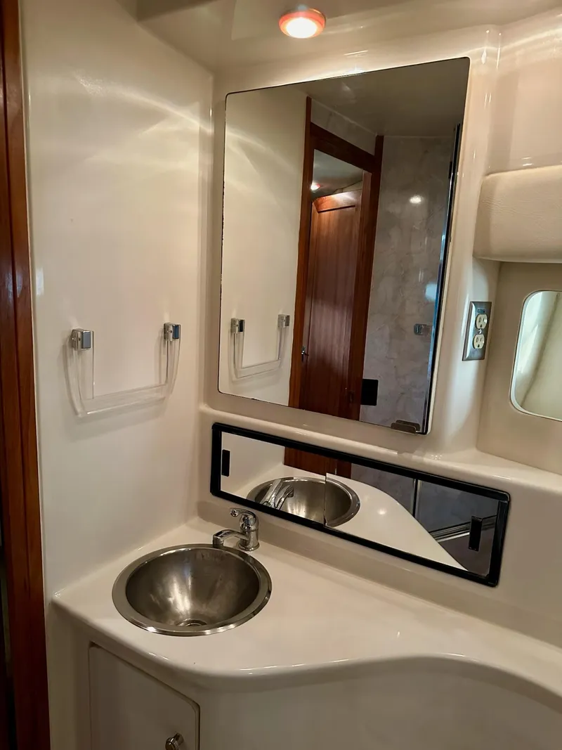 Slide: The Image of Bathroom vanity in 1997 Bayliner 3988 Motoryacht with sink, mirror, and lighting. - 20
