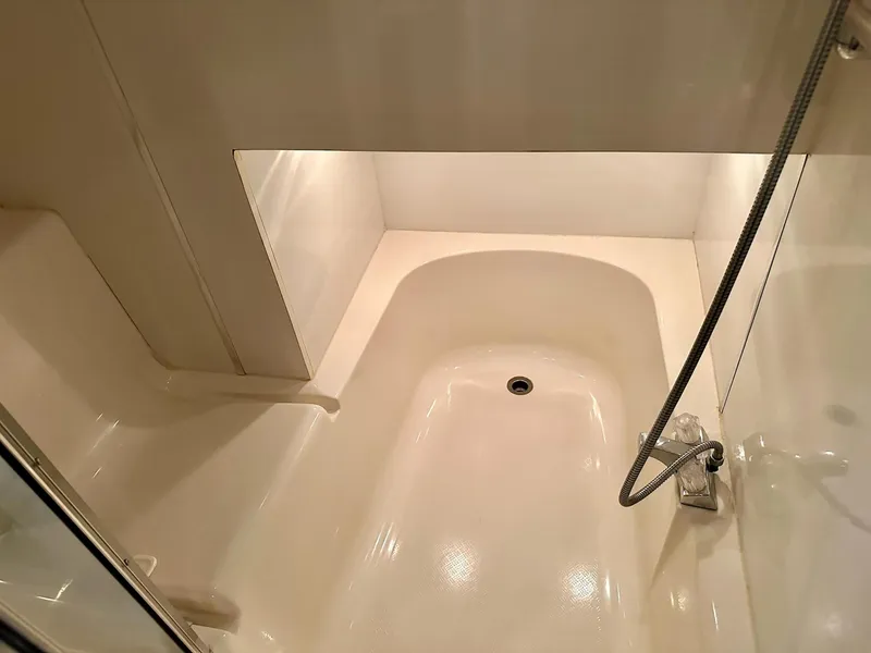 Slide: The Image of 1997 Bayliner 3988 Motoryacht bathroom with a compact shower and tub. - 21