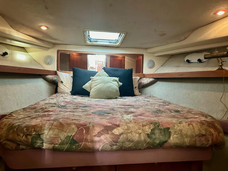 Slide: The Image of Cozy bedroom in 1997 Bayliner 3988 Motoryacht with floral bedding and soft lighting. - 24
