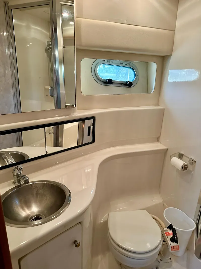 Slide: The Image of 1997 Bayliner 3988 Motoryacht bathroom with sink, toilet, and shower. - 25