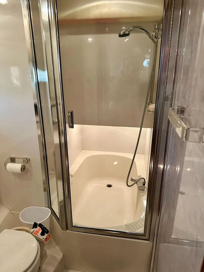 Slide: The Image of Bathroom with shower in 1997 Bayliner 3988 Motoryacht, featuring modern fixtures and compact design. - 27
