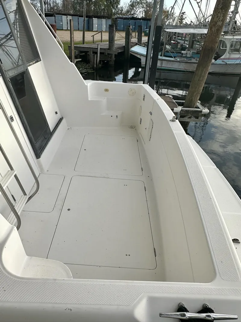 Slide: The Image of 1997 Bayliner 3988 Motoryacht deck, spacious and clean, docked at marina. - 3