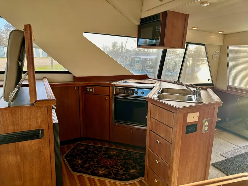 Slide: The Image of Interior of 1997 Bayliner 3988 Motoryacht kitchen with wood cabinetry and appliances. - 31