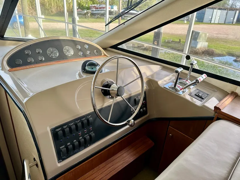 Slide: The Image of 1997 Bayliner 3988 Motoryacht helm with steering wheel and control panel. - 35