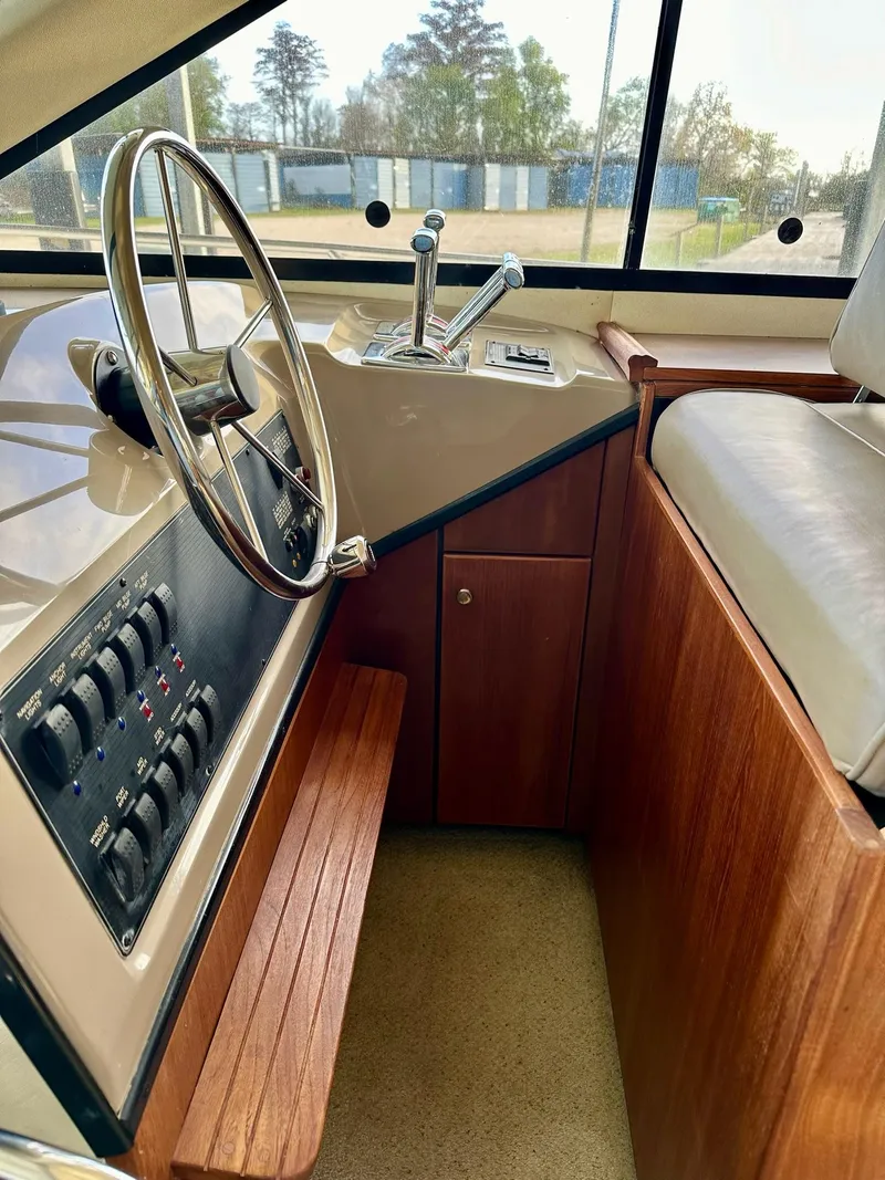 Slide: The Image of 1997 Bayliner 3988 Motoryacht helm with steering wheel and control panel. - 36