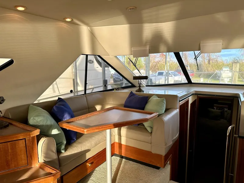 Slide: The Image of Interior of 1997 Bayliner 3988 Motoryacht with cozy seating and wooden table. - 39
