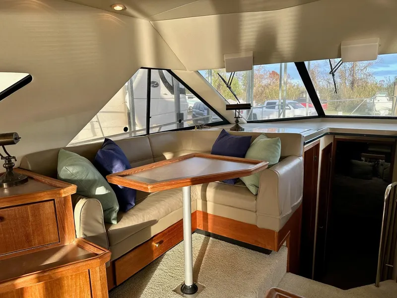 Slide: The Image of Interior of 1997 Bayliner 3988 Motoryacht with cozy seating and wooden table. - 40