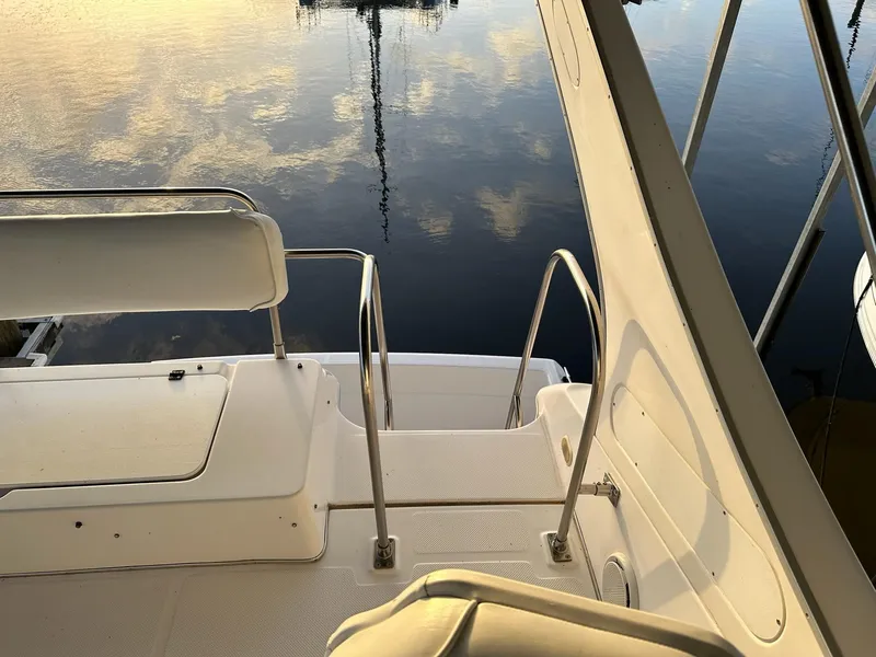 Slide: The Image of 1997 Bayliner 3988 Motoryacht deck with serene water reflection. - 7