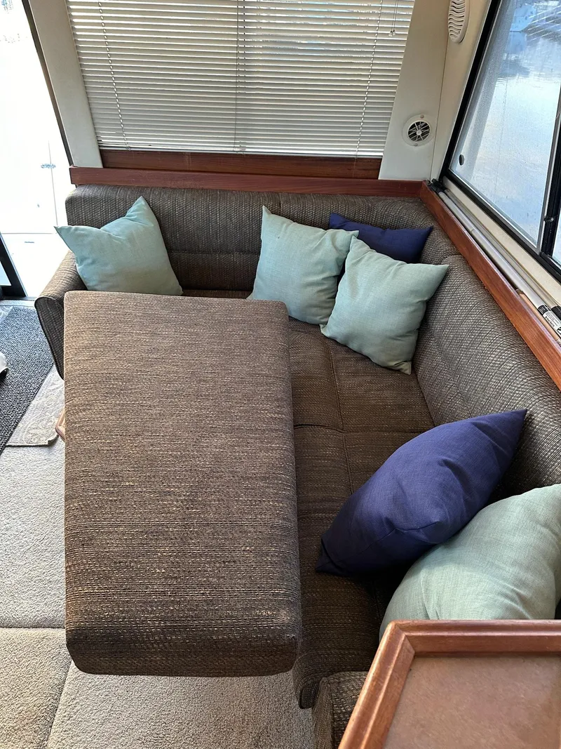 Slide: The Image of Interior of 1997 Bayliner 3988 Motoryacht with cozy seating and colorful cushions. - 8
