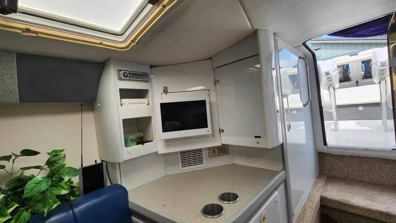 Slide: The Image of Interior of a 1996 Formula 382 SR1 boat with kitchenette and seating area. - 10