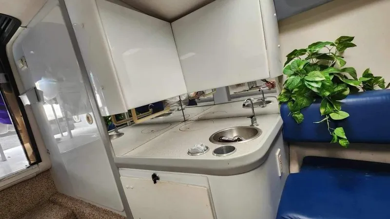 Slide: The Image of 1996 Formula 382 SR1 boat interior with kitchenette and seating area. - 12