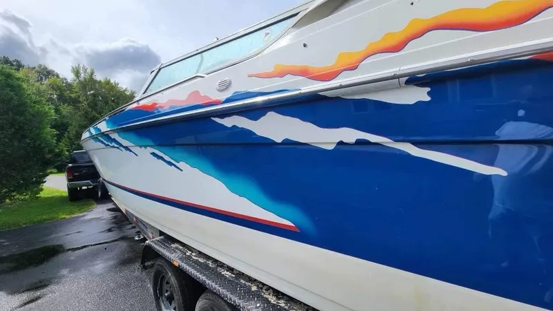 Slide: The Image of 1996 Formula 382 SR1 boat with vibrant blue and orange graphics on trailer. - 14