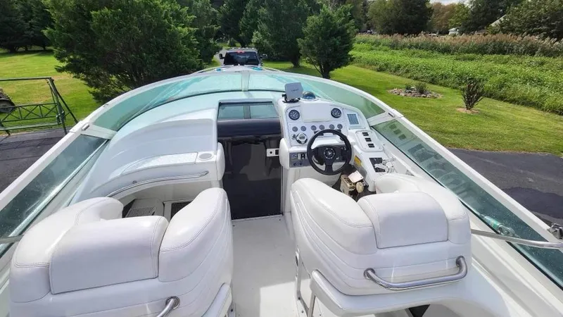 Slide: The Image of 1996 Formula 382 SR1 boat cockpit with white seats and control panel. - 3