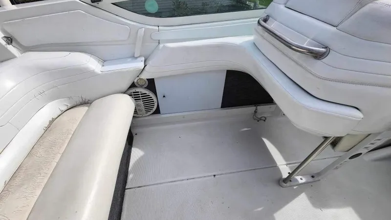 Slide: The Image of Interior of a 1996 Formula 382 SR1 boat with white seating and speaker. - 5