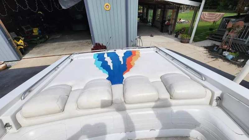 Slide: The Image of 1996 Formula 382 SR1 boat with colorful deck design and white cushioned seating. - 9