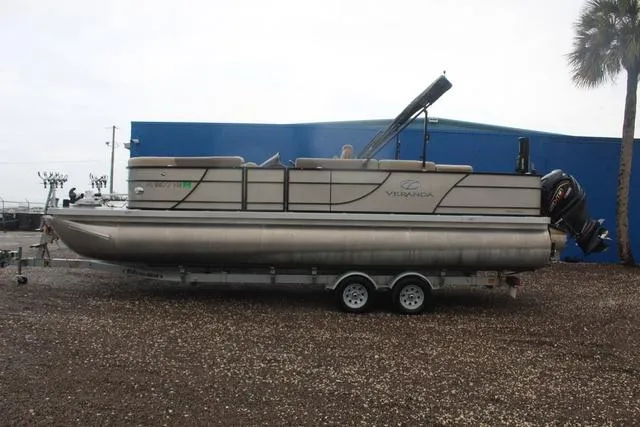 Slide: The Image of 2022 Veranda VF25F2 pontoon boat on trailer, parked outdoors. - 7