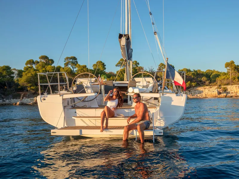 Slide: The Image of Couple relaxing on a 2024 Hanse 410 sailboat in a scenic coastal area. - 12
