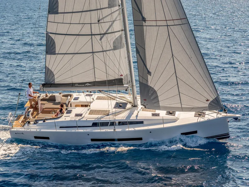 Slide: The Image of 2024 Hanse 410 sailboat cruising on open water. - 2