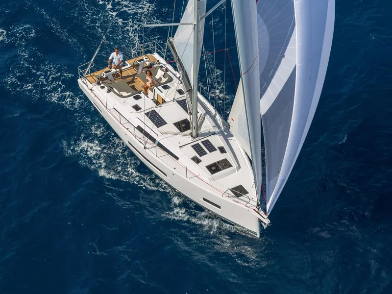 Slide: The Image of Aerial view of 2024 Hanse 410 sailboat cruising on blue ocean waters. - 7