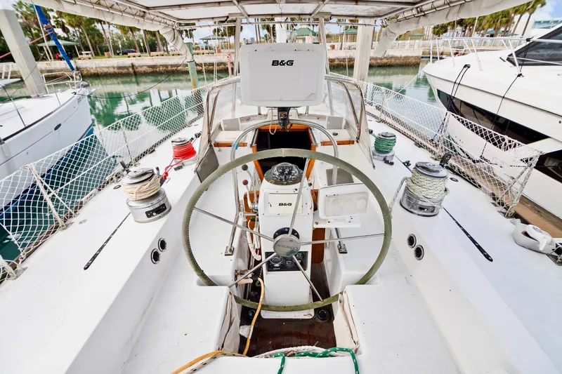 Slide: The Image of Cockpit of a 1989 Concordia 52 sailboat with steering wheel and navigation equipment. - 11