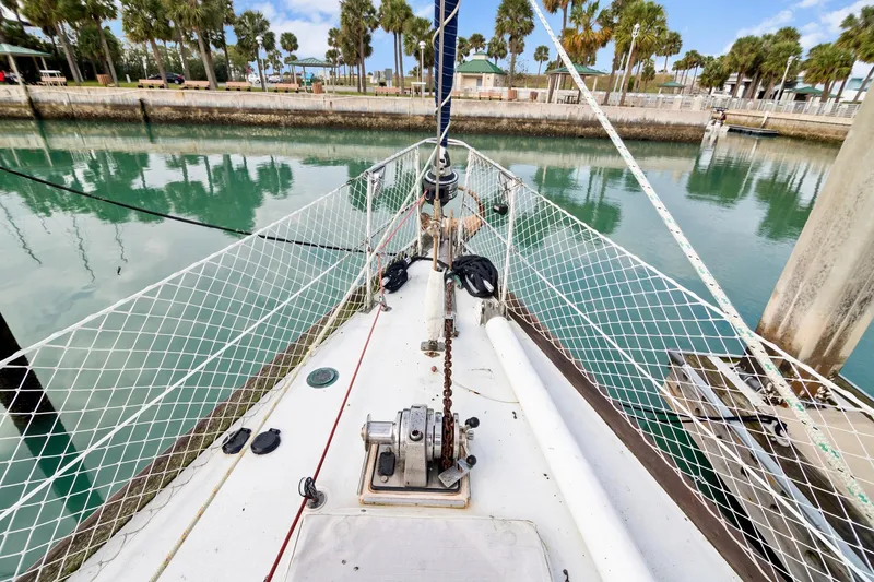 Slide: The Image of Bow of 1989 Concordia 52 sailboat docked in calm marina with palm trees. - 16