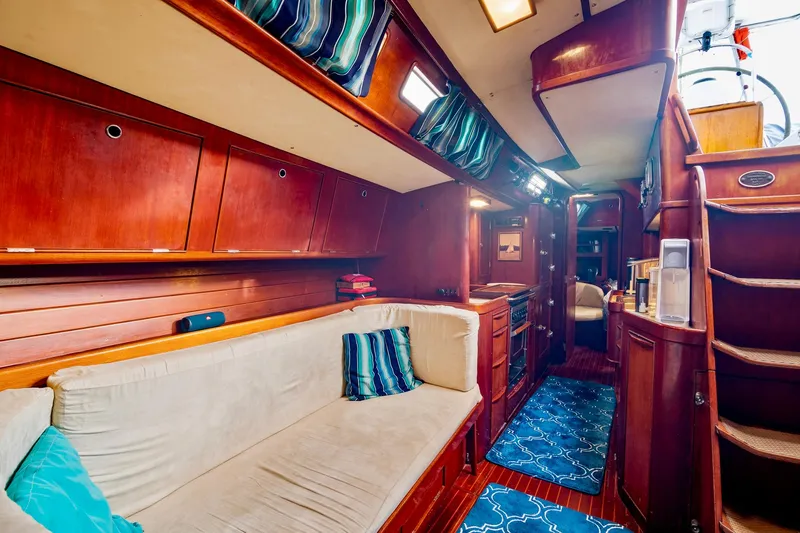 Slide: The Image of Interior of 1989 Concordia 52 yacht with wooden cabinetry and cozy seating area. - 17