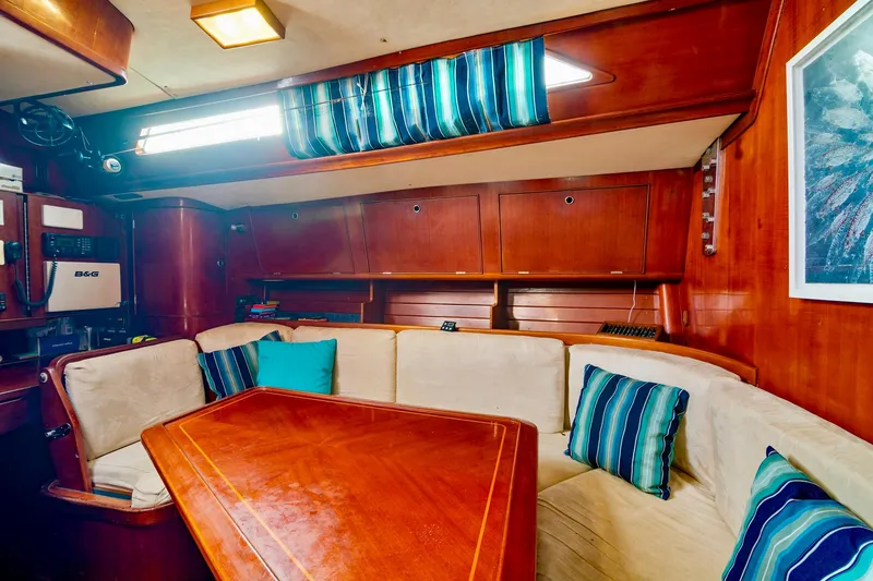 Slide: The Image of Interior of 1989 Concordia 52 yacht with wooden furnishings and cozy seating area. - 18