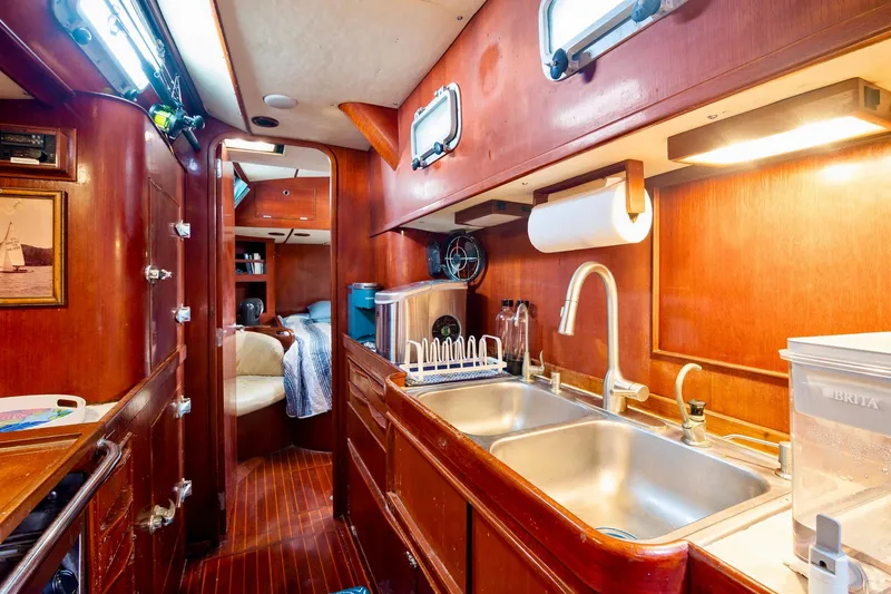 Slide: The Image of Interior of 1989 Concordia 52 yacht with wooden cabinetry and modern kitchen amenities. - 19