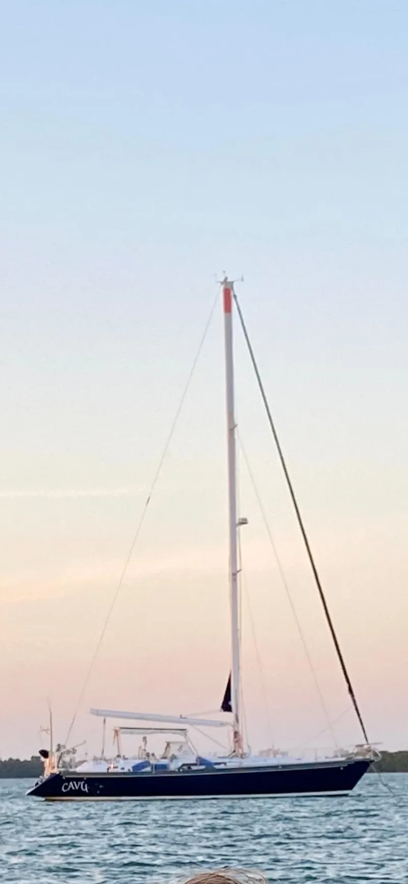 Slide: The Image of Sailing yacht Concordia 52, 1989 model, anchored on calm waters at sunset. - 2