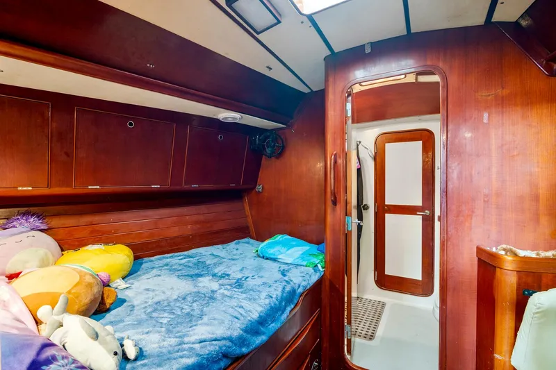 Slide: The Image of Cozy cabin interior of 1989 Concordia 52 sailboat with wooden finish and plush bedding. - 24