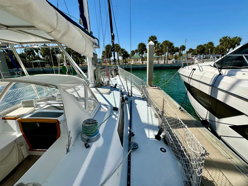 Slide: The Image of 1989 Concordia 52 sailboat docked at marina with clear blue water and palm trees. - 25